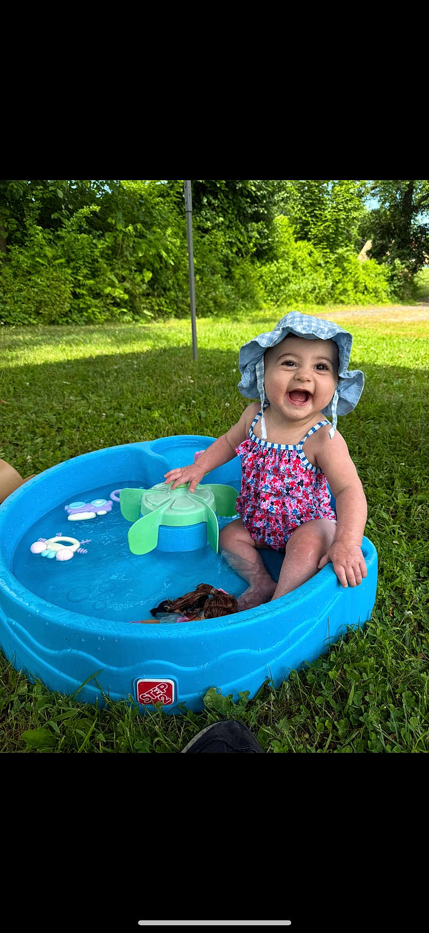 Scarlett Rae is registered to the contest to win money with this photo: baby, child, smiling, swimsuit, hat, water, pool, toy, outdoor, grass, summer, play, happy, sitting, nature, sunlight, greenery, cute, fun, water_toy
