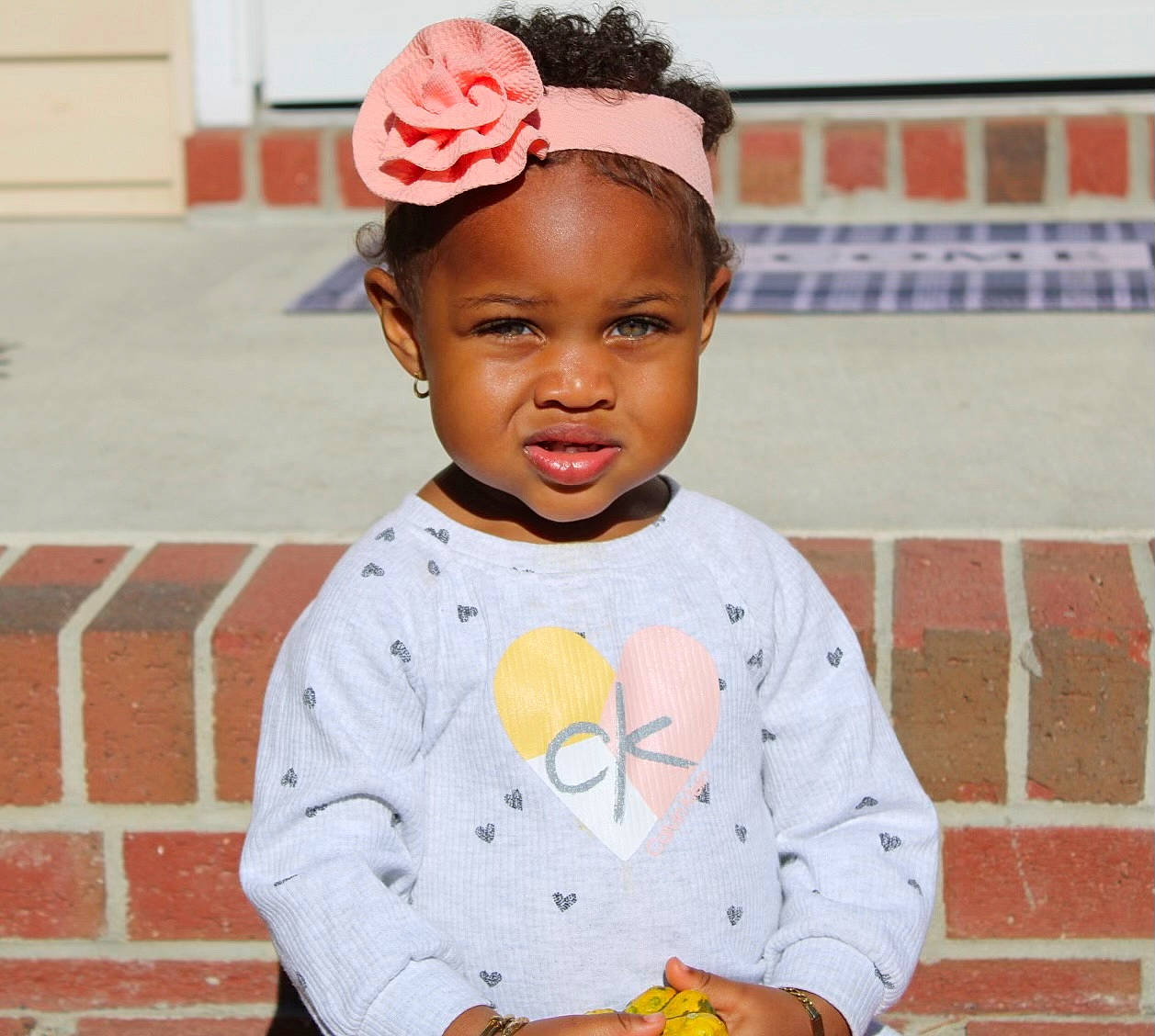 Hannah is registered to the contest to win money with this photo: baby_toddler_clothing, baseball_cap, cap, child, eye, face, fashion_accessory, happy, hat, headband, headpiece, organ, person, recreation, sitting, sleeve, smile, t_shirt, toddler, tradition