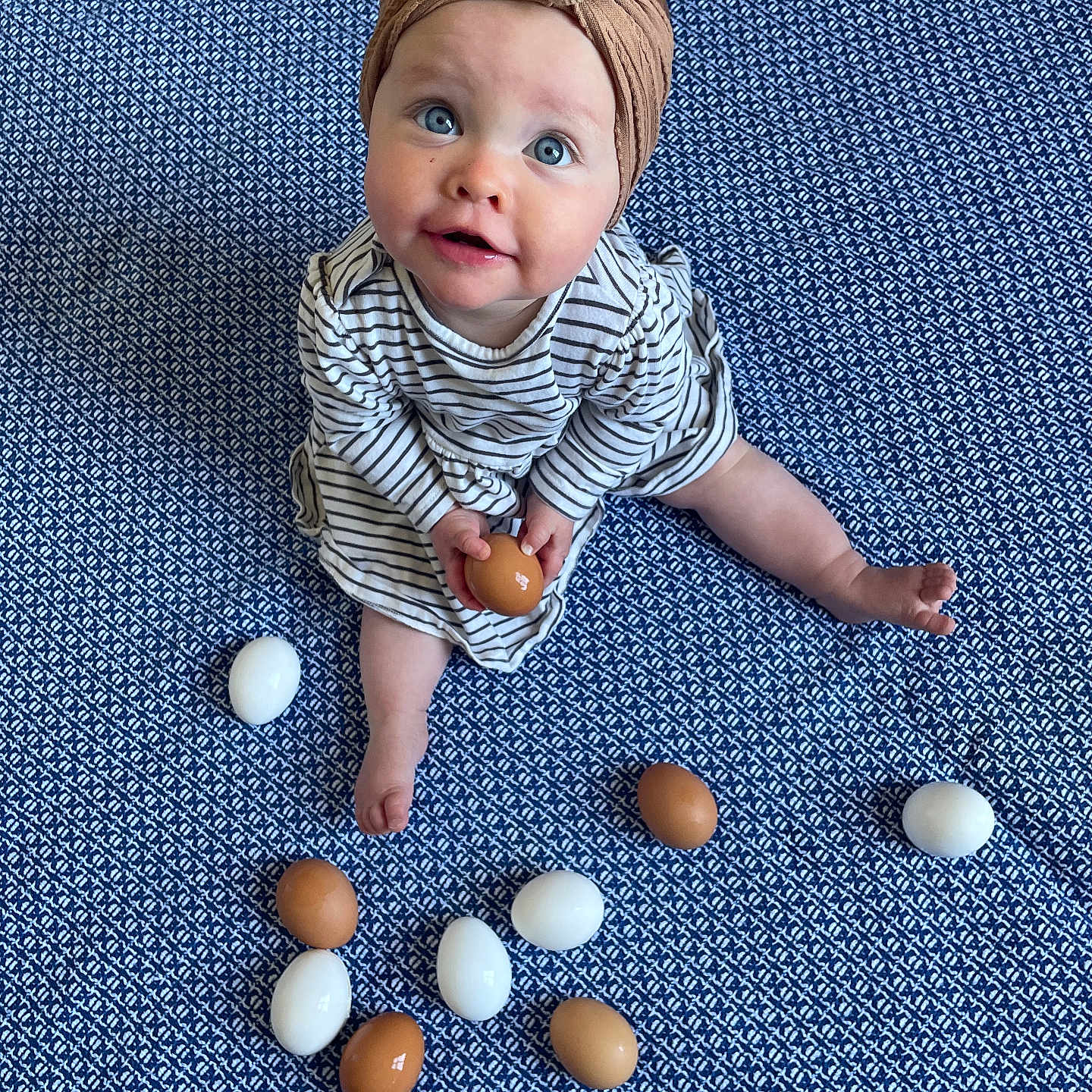 Phyllis is registered to the contest to win money with this photo: accessories, baby, babycrawling, bodypart, clothing, crawling, egg, face, finger, food, hand, hat, head, pants, people, person, photography, portrait, sitting, sphere