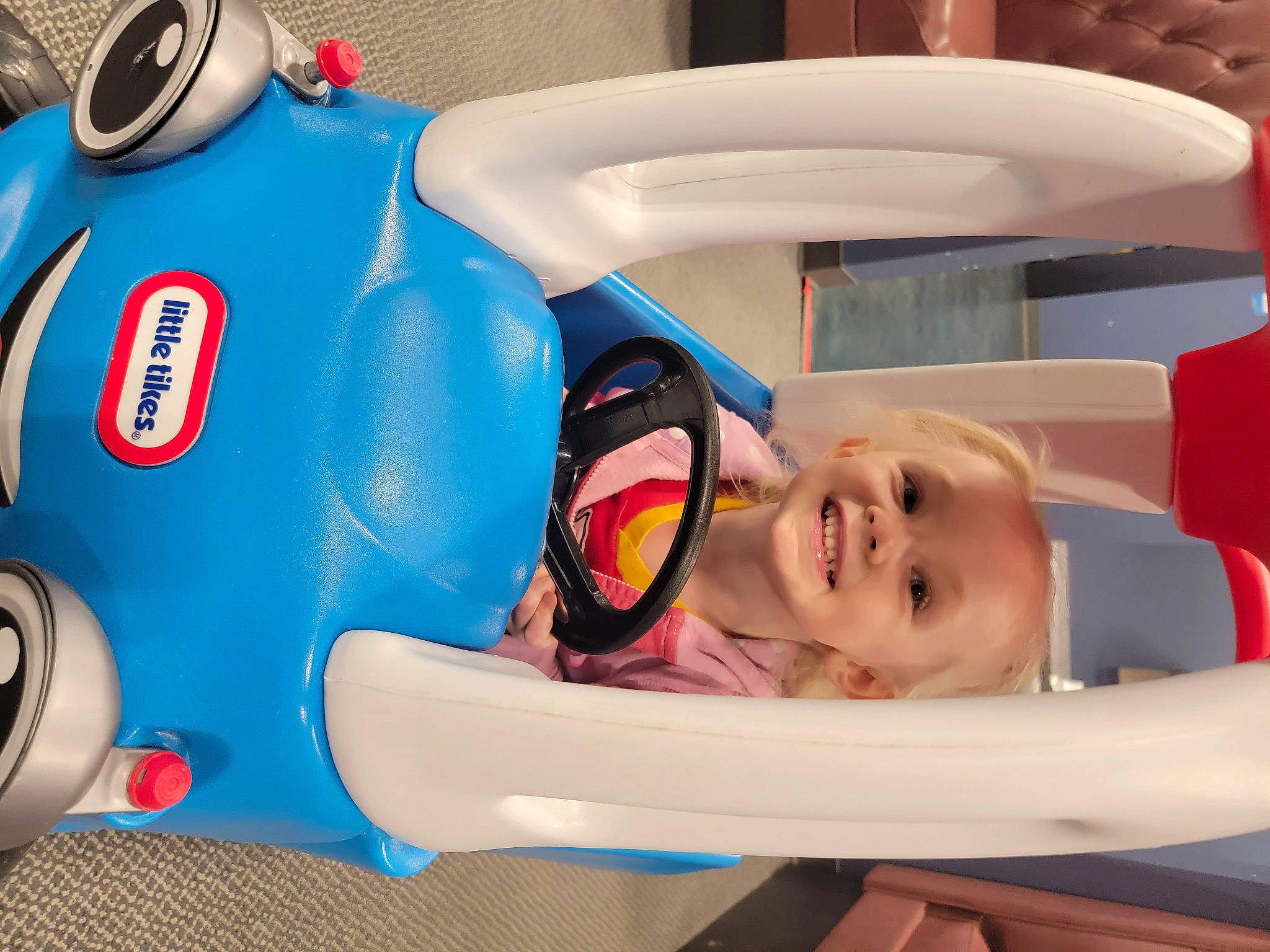 Fiona joined the competition — help win amazing prizes! automotive_design, blue, child, electric_blue, fender, fun, happy, joy, leisure, motor_vehicle, person, personal_protective_equipment, plastic, play, product, recreation, red, smile, tire, toddler