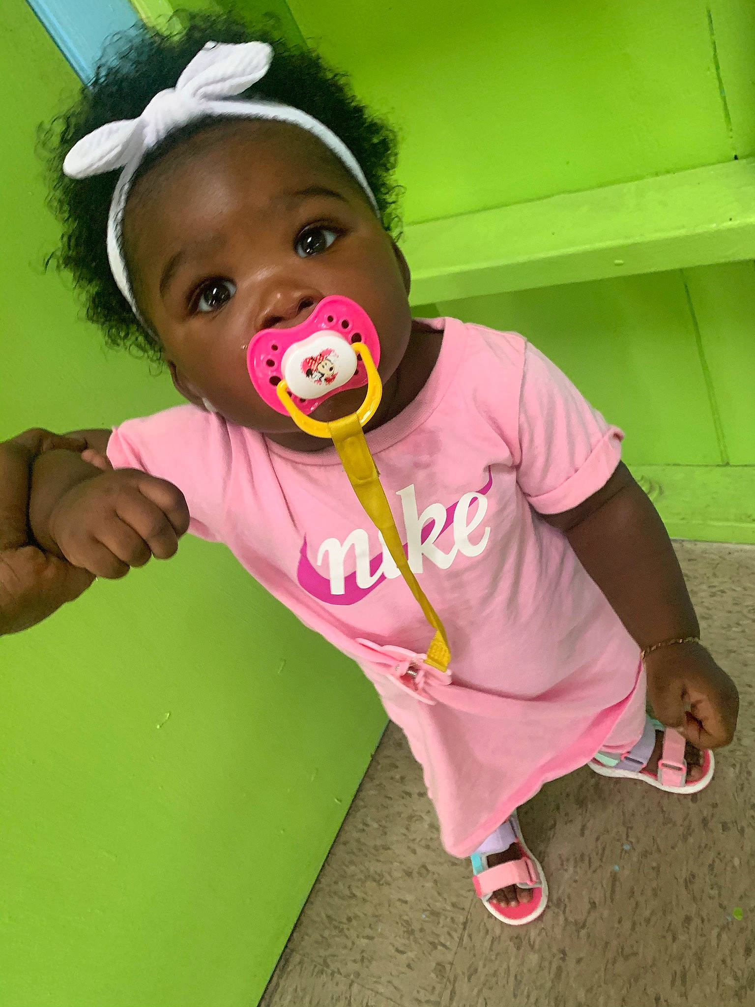 Janice is registered to the contest to win money with this photo: baby, baby_playing_with_toys, baby_toddler_clothing, baby_toys, cap, cheek, child, eyelash, face, fun, grass, happy, headgear, magenta, nose, person, pink, play, sandal, sleeve