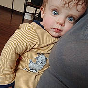Easton joined the competition — help win amazing prizes! baby, child, indoor, blue_eyes, curly_hair, striped_clothing, goat_patch, person, face, cute, toddler, holding, floor, chair, clothing, portrait, expression, comfort, closeup, soft_light