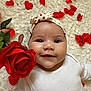Maëly participe au concours pour gagner de l'argent avec cette photo : baby, infant, smile, headband, heart_pattern, rose, flower, red_petal, white_clothing, fluffy_background, cute, happy, portrait, closeup, soft_texture, child, person, celebration, love, adorable