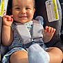baby, child, smiling, car_seat, safety_harness, sock, floral_dress, pony_tail, happy, indoors, seat_belt, infant, cute, sunlight, person, portrait, toddler, seat, clothing, hands