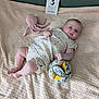 baby, infant, blanket, plush_toy, octopus_toy, fabric_ball, card, milestone_card, clothing, cute, lying_down, indoor, soft_texture, patterned_outfit, child, adorable, baby_girl, skin, head, face