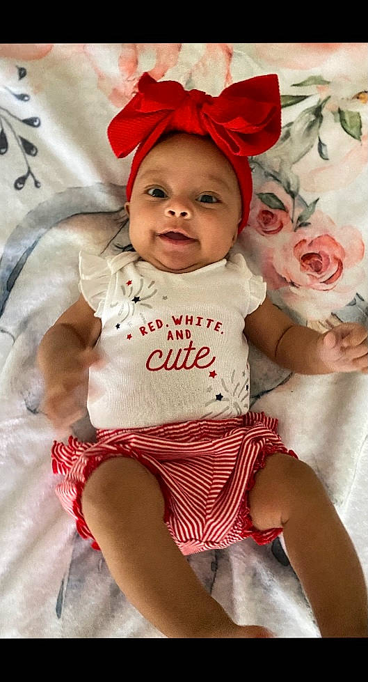 Imani joined the competition — help win amazing prizes! baby, baby_toddler_clothing, beauty, cheek, child, eye, face, facial_expression, happy, hat, head, headwear, lip, person, pink, red, skin, sleeve, smile, textile