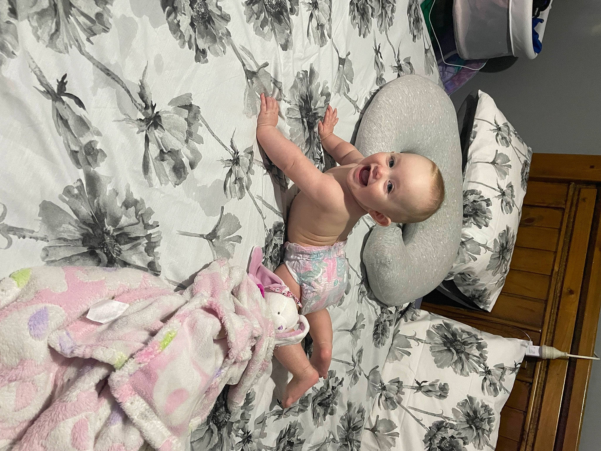 Nevaeh is registered to the contest to win money with this photo: arm, baby, baby_toddler_clothing, bed, bedding, child, comfort, fun, happy, hat, leisure, linens, pattern, person, pink, room, sitting, t_shirt, textile, thigh
