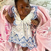 Azalea is registered to the contest to win money with this photo: baby, blanket, blue, bow, child, cute, dress, fabric, girl, headband, indoors, infant, pacifier, person, pink, portrait, sleepwear, socks, soft, white
