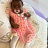 Azalea is registered to the contest to win money with this photo: baby, bed, blanket, bow, butterfly_pattern, child, cozy, cute, headband, indoors, infant, lying_down, pacifier, person, pillow, pink_dress, portrait, resting, soft_lighting, white_tights