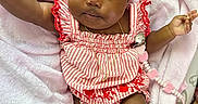 Azalea is registered to the contest to win money with this photo: adorable, baby, barefoot, child, chubby_cheeks, cute, expression, gold_necklace, headband, indoors, infant, lying_down, pacifier_clip, pink_blanket, red_bow, relaxed, ruffled_sleeves, skin, soft_texture, striped_clothing