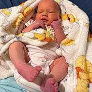 Florence is registered to the contest to win money with this photo: awake, baby, blanket, child, cozy, face, family_photo, feet, hands, indoors, infant, lying_down, newborn, onesie, portrait, sleeping, smiling, soft_blanket, striped_clothing, swaddle