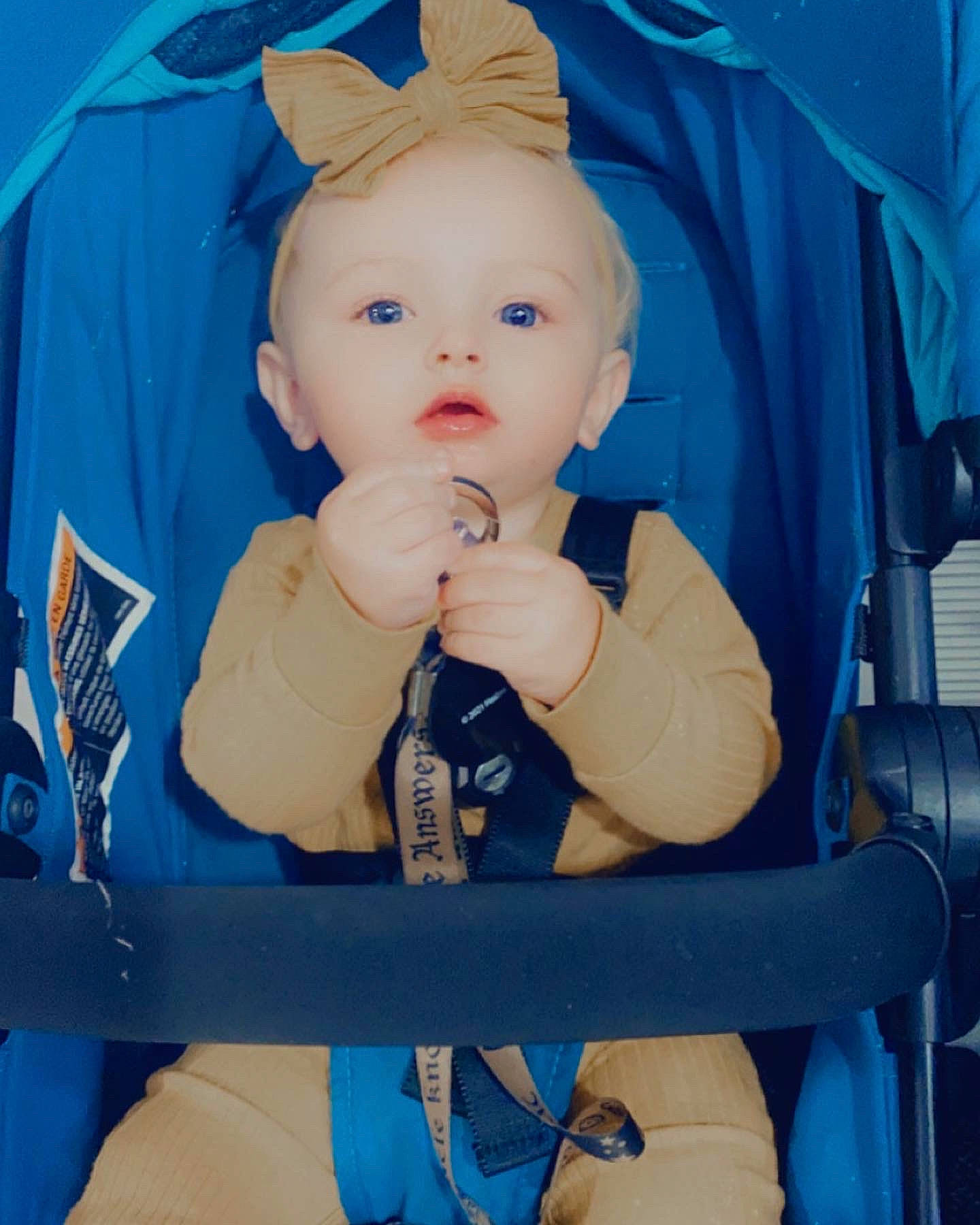 Miyah is registered to the contest to win money with this photo: azure, baby, baby_carriage, baby_products, baby_safety, baby_toddler_clothing, blue, cheek, child, comfort, electric_blue, eye, fun, happy, person, product, sitting, sleeve, thumb, toddler