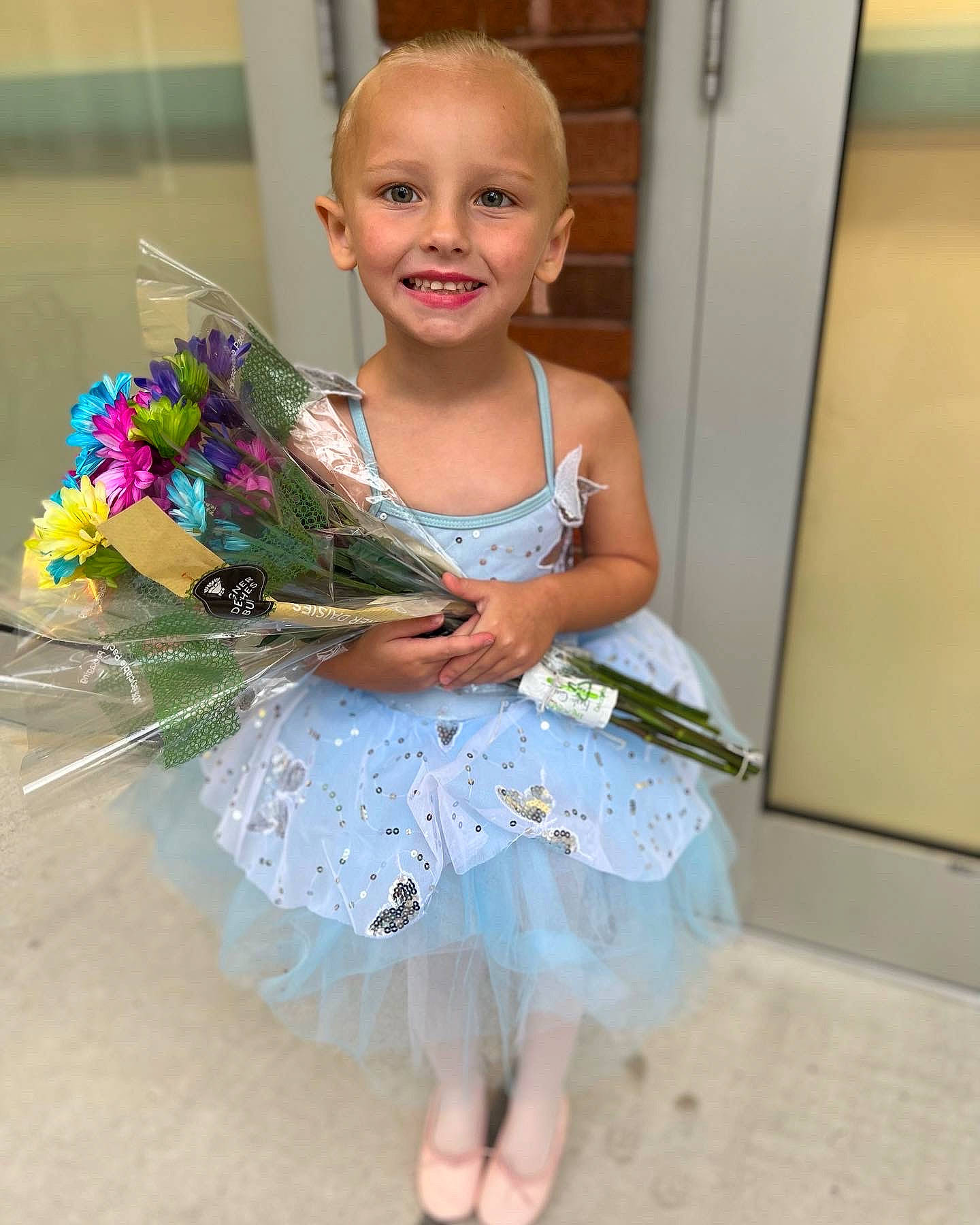 Kyndall is registered to the contest to win money with this photo: baby_toddler_clothing, barefoot, child, costume, cut_flowers, day_dress, face, fashion_accessory, fashion_design, flower, foot, fun, happy, head, human_leg, iris, jewellery, joy, person, play