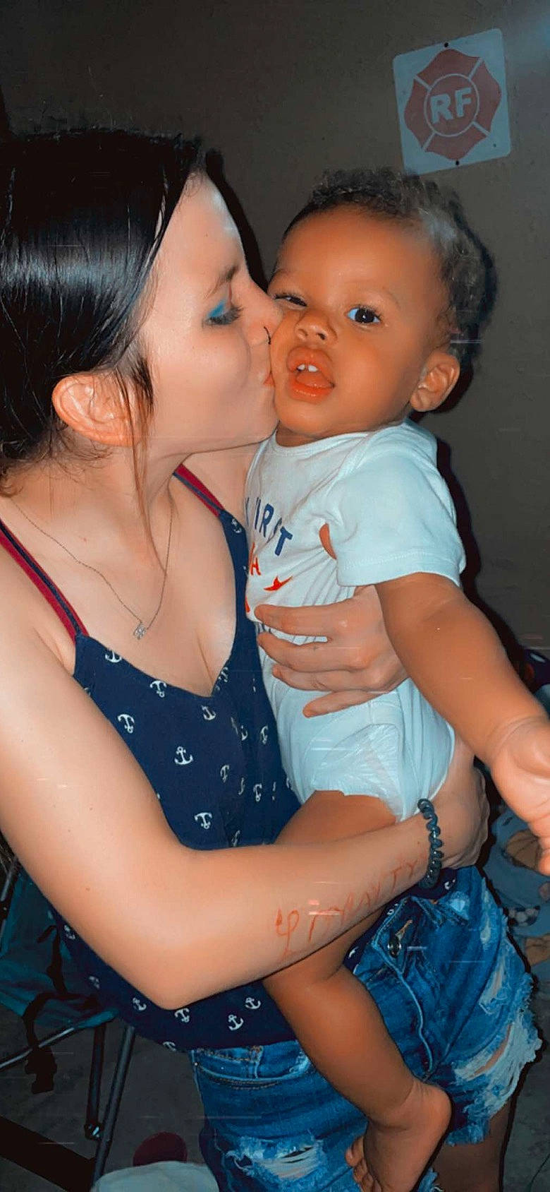 Jay is registered to the contest to win money with this photo: arm, baby_toddler_clothing, blue, cheek, chin, ear, facial_expression, finger, gesture, happy, interaction, iris, kiss, lip, neck, nose, organ, person, skin, smile