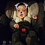 baby, car_seat, child, face_filter, dog_ears, dog_nose, sparkles, harness, dark_background, infant, cute, expression, seated, clothing, indoors, baby_girl, baby_boy, portrait, photography, technology