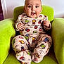 Arthur participe au concours pour gagner de l'argent avec cette photo : baby, child, marvel, pajamas, green_armchair, happy, smiling, cute, infant, indoor, clothing, seated, person, face, wide_eyes, expression, furniture, cozy, soft_fabric, comfortable