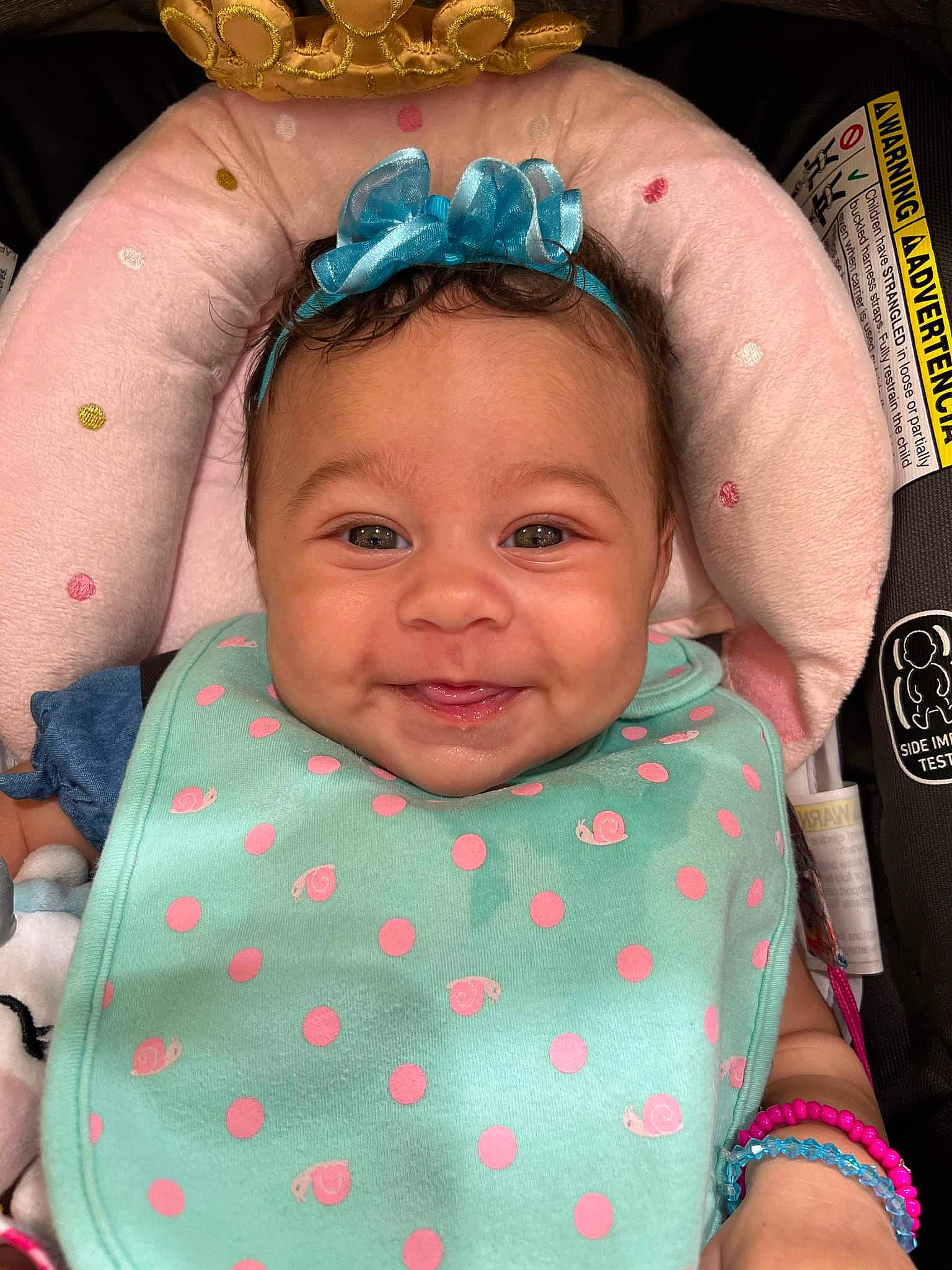 India is registered to the contest to win money with this photo: baby, baby_toddler_clothing, cheek, chin, eye, eyelash, face, facial_expression, green, happy, head, iris, lip, mouth, organ, person, pink, skin, smile, textile