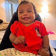 Sahasra joined the competition — help win amazing prizes! baby, child, smiling, red_shirt, mickey_mouse, bracelet, indoor, lamp, bedroom, happy, person, clothing, shorts, star_pattern, infant, young_child, cute, sitting, portrait, home