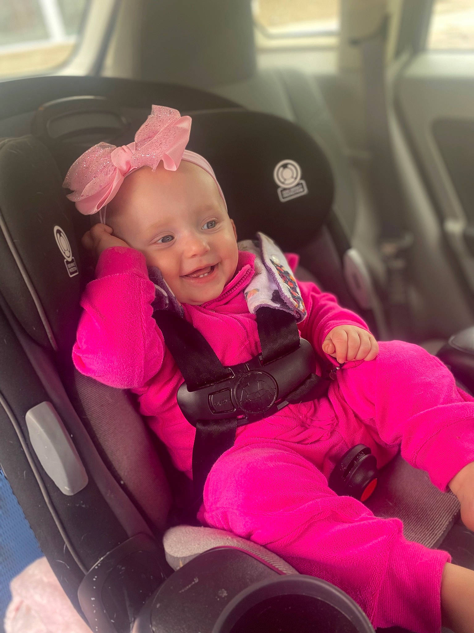 Daisy joined the competition — help win amazing prizes! auto_part, automotive_design, automotive_exterior, baby, baby_toddler_clothing, car, car_seat, car_seat_cover, comfort, happy, head_restraint, joy, magenta, motor_vehicle, person, pink, seat_belt, smile, steering_wheel, toddler
