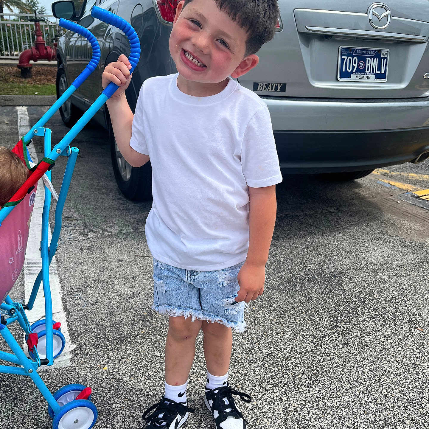 Tylen is registered to the contest to win money with this photo: boy, child, city, clothing, face, footwear, head, machine, male, pants, person, photography, portrait, road, shoe, shorts, street, summer, urban, wheel