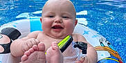 Parker is registered to the contest to win money with this photo: baby, pool, inflatable_ring, donald_duck, water, smiling, outdoor, summer, child, toy, snorkel_mask, blue_water, sunny, playful, feet, happy, floating, backyard, cute, inflatable