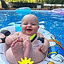 baby, pool, inflatable_ring, donald_duck, water, smiling, outdoor, summer, child, toy, snorkel_mask, blue_water, sunny, playful, feet, happy, floating, backyard, cute, inflatable