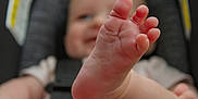 Maylynn joined the competition — help win amazing prizes! baby, foot, toes, infant, car_seat, smile, child, skin, closeup, blurred_background, seatbelt, human, cute, soft_light, indoor, childhood, baby_clothes, playful, small, person