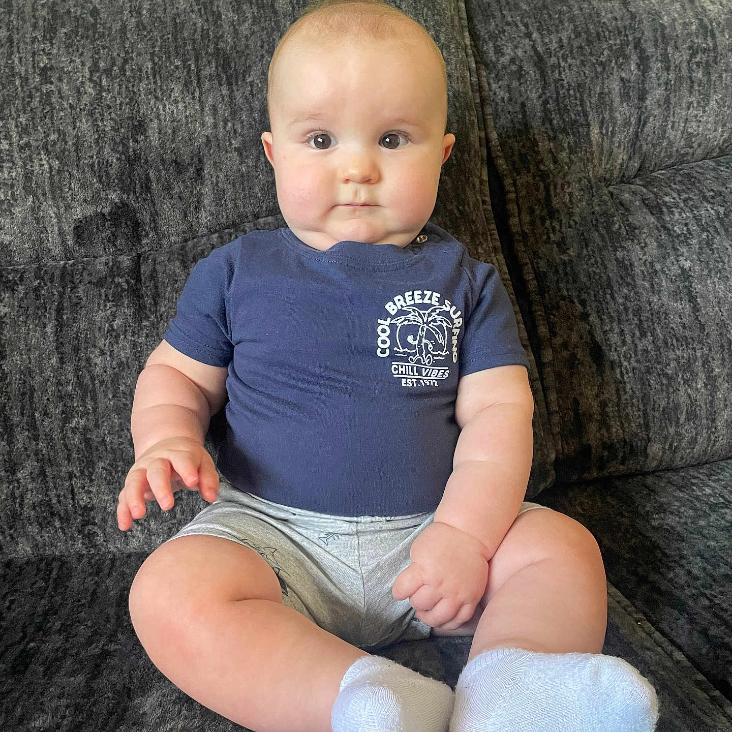 Cayden is registered to the contest to win money with this photo: baby, chair, clothing, couch, cushion, face, furniture, head, homedecor, hosiery, jeans, pants, person, photography, portrait, shorts, sitting, sleeve, sock, t_shirt