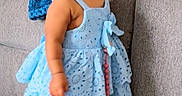 Nasya Ellie joined the competition — help win amazing prizes! child, toddler, baby, portrait, standing, dress, blue_dress, shoes, white_shoes, sofa, couch, blanket, living_room, indoors, wooden_floor, gift_bag, fashion, serious_expression, looking_at_camera, jewelry