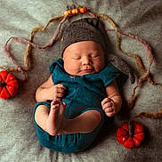 Reuben is registered to the contest to win money with this photo: autumn_theme, baby, blanket, cozy, cute, feet, felt_pumpkins, grey_hat, hands, hat, indoors, infant, newborn, peaceful, portrait, resting, sleeping, soft_texture, teal_outfit, woolen_strands