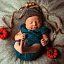autumn_theme, baby, blanket, cozy, cute, feet, felt_pumpkins, grey_hat, hands, hat, indoors, infant, newborn, peaceful, portrait, resting, sleeping, soft_texture, teal_outfit, woolen_strands