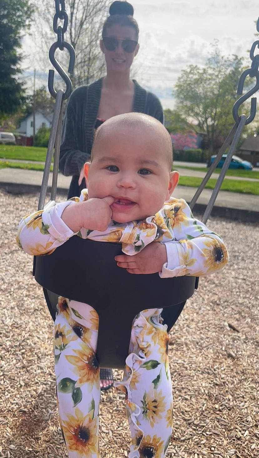 Nola is registered to the contest to win money with this photo: baby, baby_toddler_clothing, child, city, face, fun, grass, happy, head, joy, leisure, mammal, people, person, plant, playground, sky, smile, swing, toddler