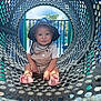 toddler, child, playground, hat, overalls, sitting, tunnel, sunlight, shadows, outdoor, play, baby, cute, smiling, feet, clothing, daylight, metal, pattern, fun