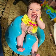 Isabelle joined the competition — help win amazing prizes! baby, blue_seat, carpet, child, clothing, cute, expression, furniture, happy, indoor, infant, person, playful, portrait, sitting, smile, toy, yellow_shirt, young_child, giggle