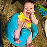 baby, blue_seat, carpet, child, clothing, cute, expression, furniture, happy, indoor, infant, person, playful, portrait, sitting, smile, toy, yellow_shirt, young_child, giggle