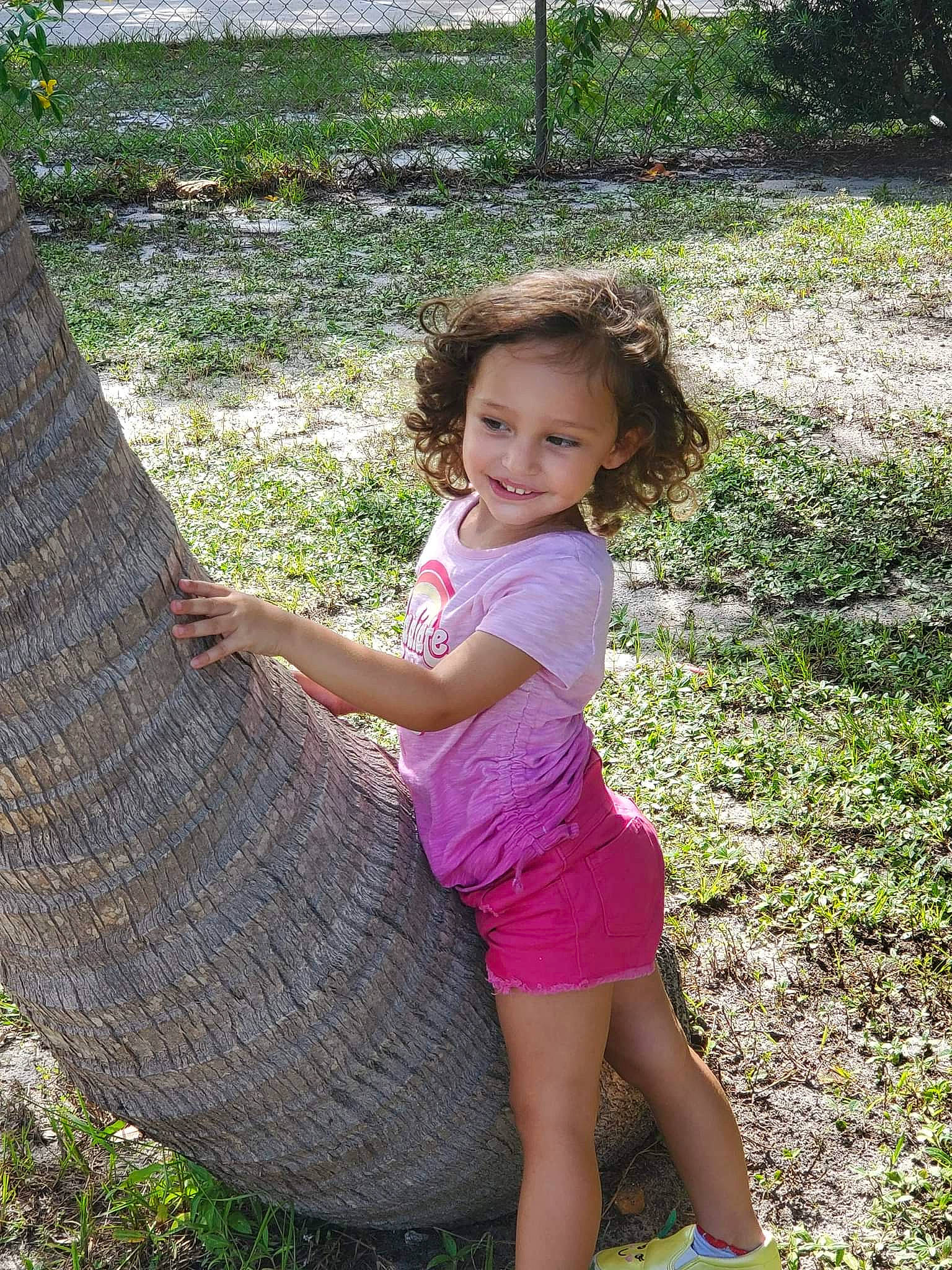 Rosalie is registered to the contest to win money with this photo: adaptation, dress, fun, grass, grass_family, groundcover, happy, joy, landscape, leisure, people_in_nature, person, plant, shorts, smile, thigh, toddler, tree, trunk, wilderness