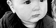 Sergio participe au concours pour gagner de l'argent avec cette photo : adult_hand, baby, black_and_white, child, closeup, clothing, curious, expression, face, gentle, hand, holding, indoor, infant, nail_polish, person, portrait, sitting, skin, young