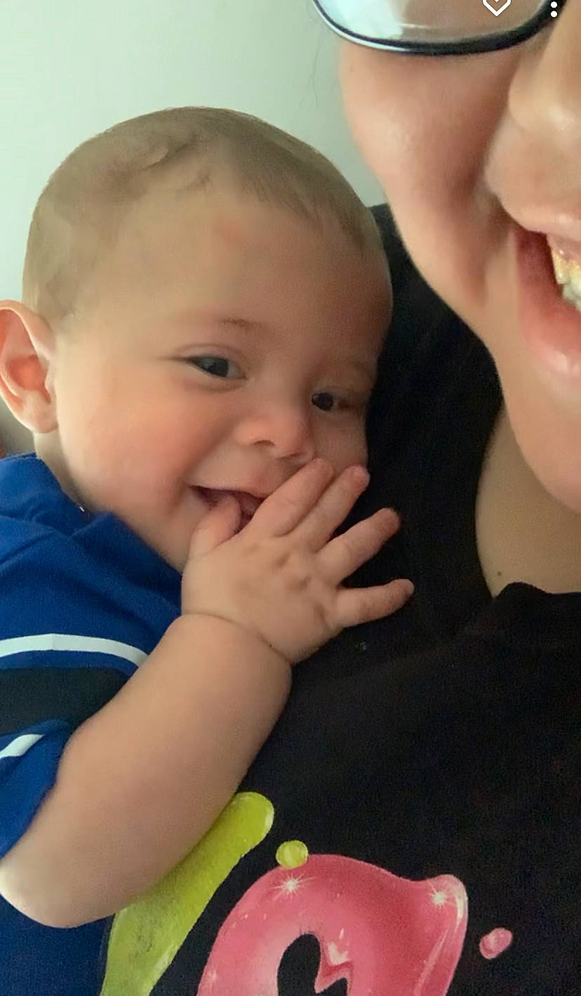 Niklaus is registered to the contest to win money with this photo: baby_toddler_clothing, cheek, chin, ear, eyebrow, eyelash, finger, gesture, hand, happy, iris, lip, mouth, neck, nose, organ, person, pink, skin, smile