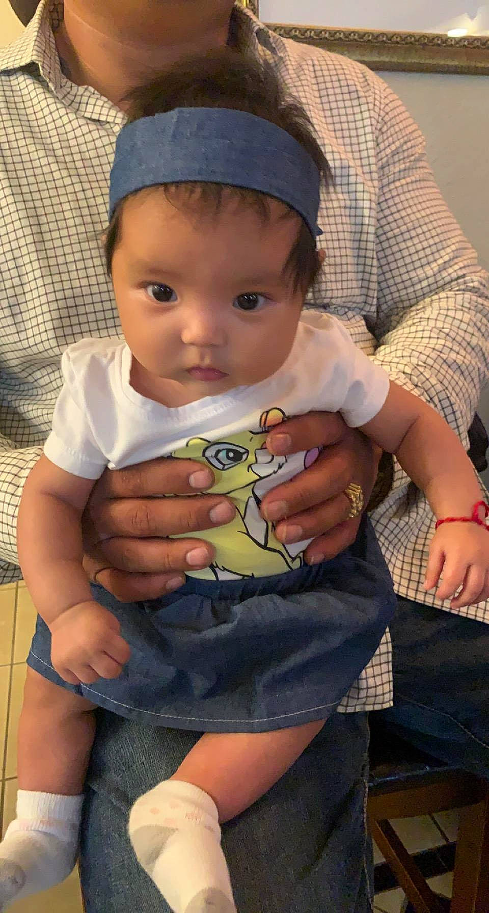 Moana joined the competition — help win amazing prizes! baby, baby_toddler_clothing, cap, cheek, child, facial_expression, finger, fun, hairstyle, hat, lap, mouth, nail, person, product, sitting, skin, sleeve, thigh, thumb