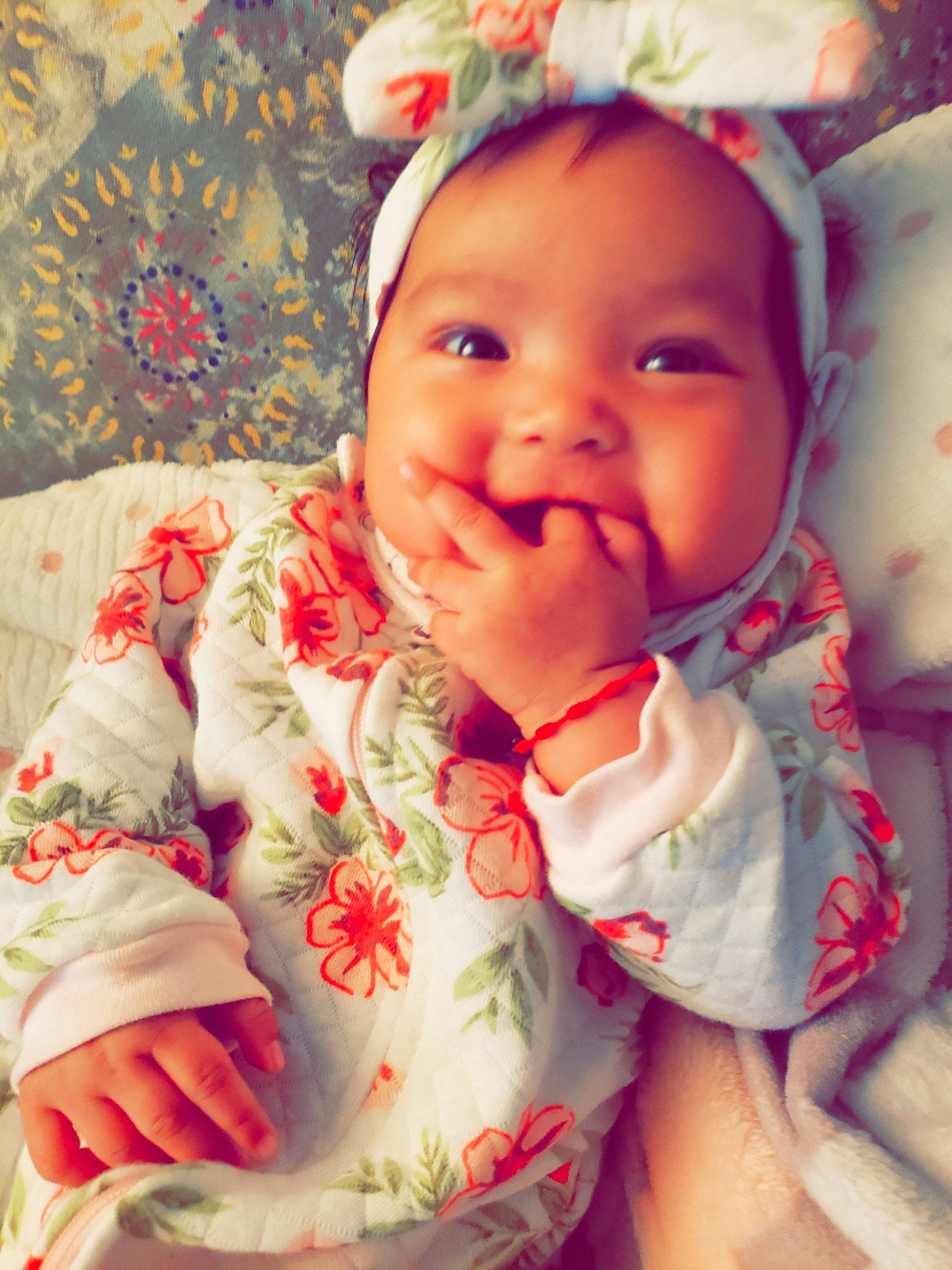 Moana is registered to the contest to win money with this photo: baby, baby_toddler_clothing, cheek, chin, dress, eye, facial_expression, finger, happy, head, iris, lip, mouth, nose, person, pink, skin, sleeve, smile, textile