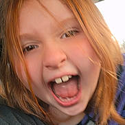 Brandy is registered to the contest to win money with this photo: child, red_hair, open_mouth, car_interior, close_up, joyful, happy, face, person, candid, mouth, teeth, hair, seat, window, clothing, portrait, emotion, excited, casual