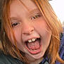 child, red_hair, open_mouth, car_interior, close_up, joyful, happy, face, person, candid, mouth, teeth, hair, seat, window, clothing, portrait, emotion, excited, casual