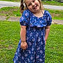 child, girl, smiling, blue_dress, floral_pattern, grass, outdoor, sandals, happy, greenery, nature, pigtails, portrait, cute, playful, summer, daylight, casual, person, standing