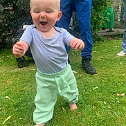 Adonis Joe is registered to the contest to win money with this photo: toddler, child, grass, outdoor, happy, walking, smile, greenery, plants, adult, pants, blue_shirt, barefoot, garden, person, nature, summer, casual, step, joy