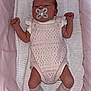 newborn, baby, infant, pacifier, knitted_clothing, pink, socks, blanket, bassinet, sleeping, cute, small, resting, indoors, child, person, soft, fabric, cozy, peaceful