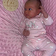 Willow is registered to the contest to win money with this photo: baby, infant, pink_blanket, pink_clothing, bunny_prints, soft_texture, wooden_plaque, one_month, milestone, newborn, socks, cute, portrait, laying_down, face, hand, footwear, sleepwear, indoors, child