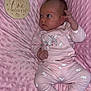 baby, infant, pink_blanket, pink_clothing, bunny_prints, soft_texture, wooden_plaque, one_month, milestone, newborn, socks, cute, portrait, laying_down, face, hand, footwear, sleepwear, indoors, child