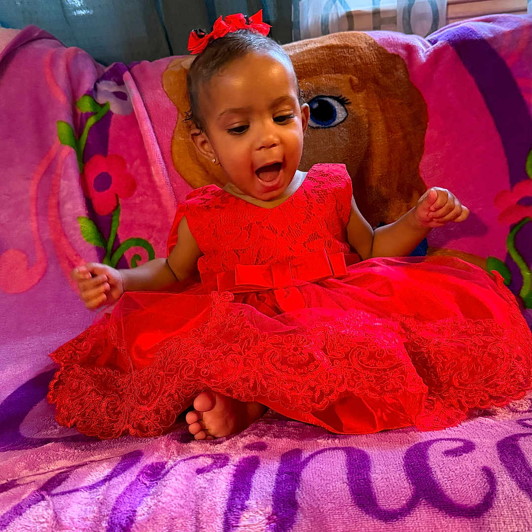 Esteisy joined the competition — help win amazing prizes! blanket, bow, child, colorful, curtains, excited, fabric, face, feet, happy, home, indoors, portrait, princess_theme, red_dress, sitting, smiling, toddler, window, young_child