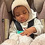 Esteisy is registered to the contest to win money with this photo: baby, sleeping, car_seat, knit_hat, pom_pom, blanket, pacifier, child, infant, cozy, warm_clothing, cute, resting, indoors, soft_texture, toddler, safety_harness, peaceful, headwear, bundle