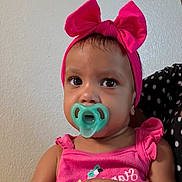 Esteisy joined the competition — help win amazing prizes! toddler, child, pacifier, pink_bow, headband, pink_clothing, indoor, portrait, hands, face, curious, baby, young_child, polka_dot, person, cute, expression, skin, closeup, sitting